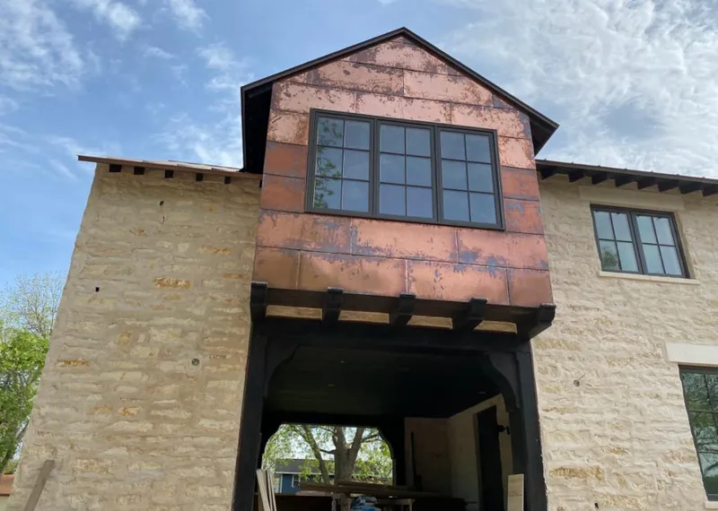 Copper metal panel facade on a stone building for Metal Roof Coating in Shafter